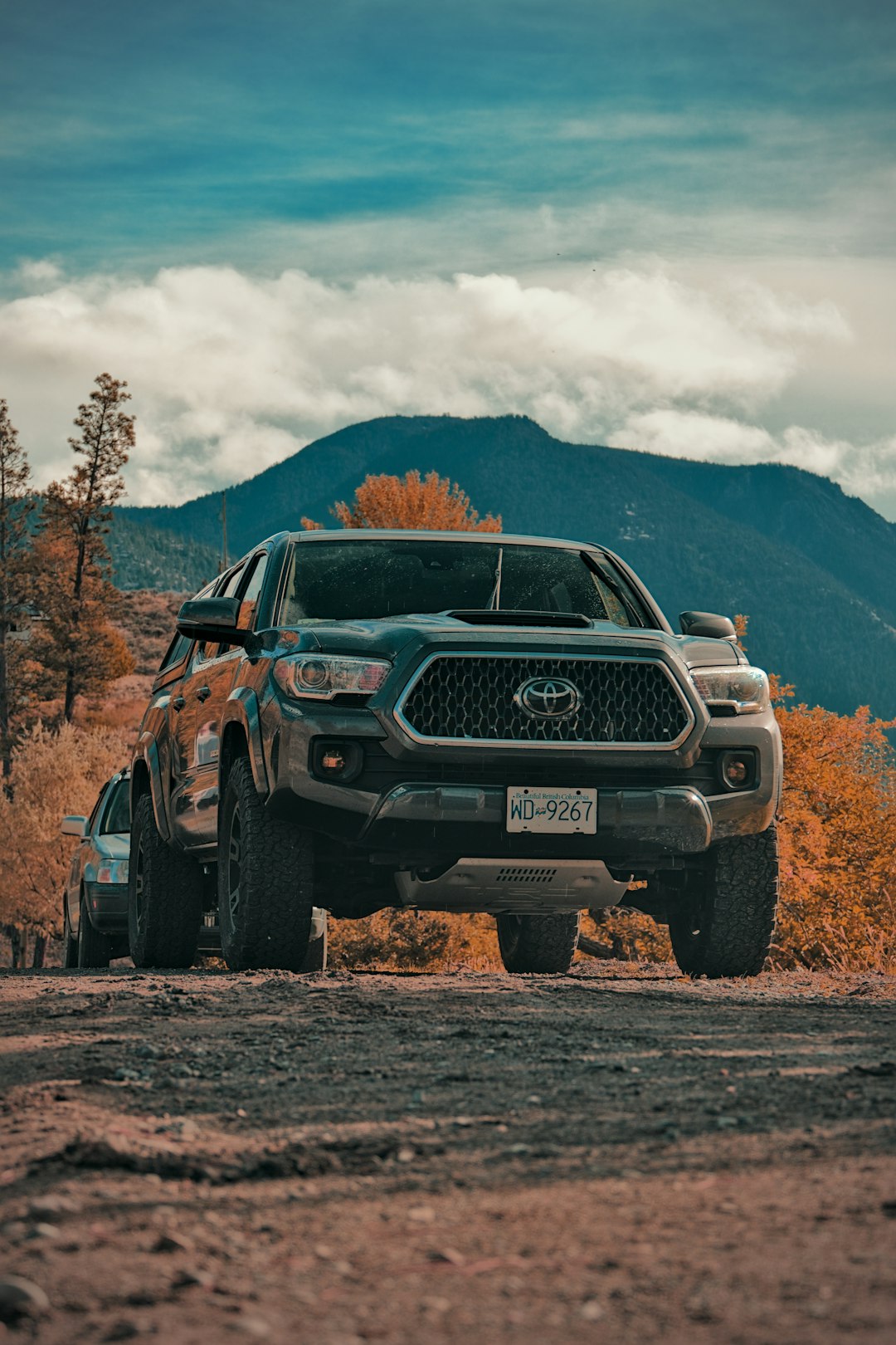 about-02 a-truck-is-parked-on-a-dirt-road-vf-ppd44iyi