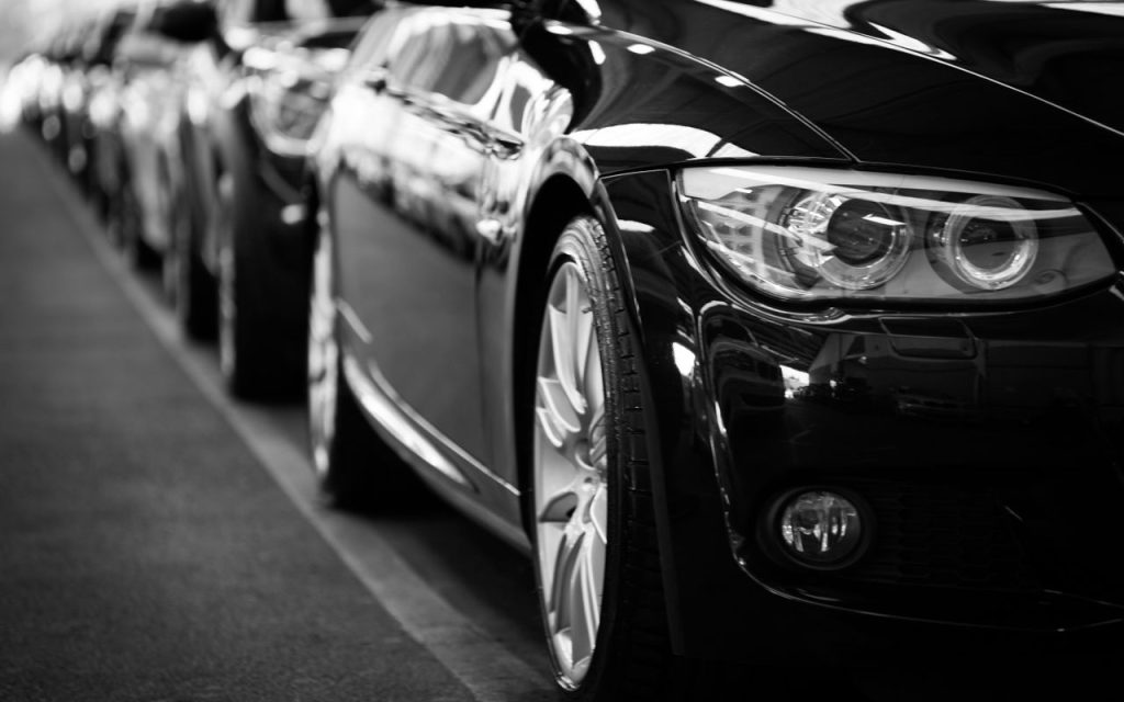 Crafting Captivating Headlines: Your awesome post title goes here Close-up black and white image of a luxury car line-up focusing on vehicle headlights.