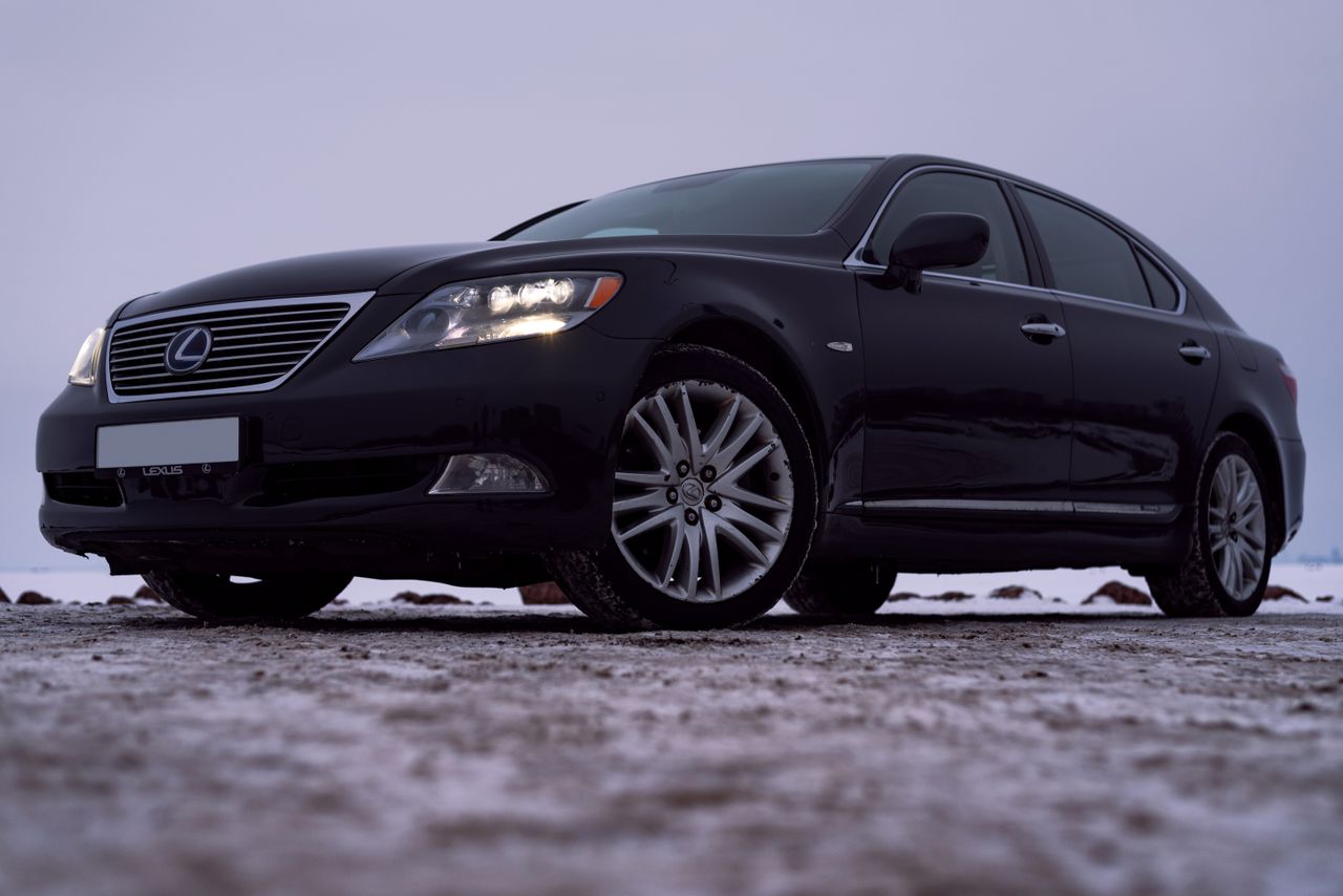 services-09 Sleek black Lexus LS 460 in a winter parking lot. Luxury car with bold design.